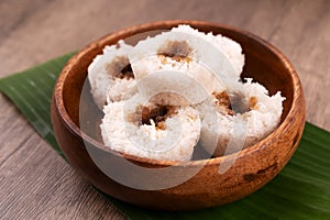 Putu bambu or steamed rice flour cake with grated coconut and palm sugar filling photo