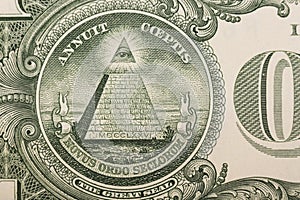 Close up of the pyramid and eye on the back of a one dollar bill
