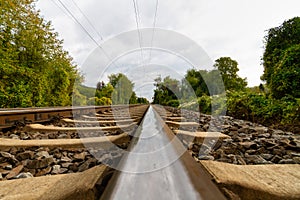 Close-up of railroad tracks leading straight foreward to infinity