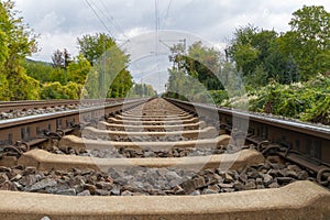 Close-up of railroad tracks leading straight foreward to infinity