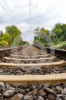 Close-up of railroad tracks leading straight foreward to infinity