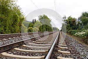 Close-up of railroad tracks leading straight foreward to infinity