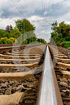 Close-up of railroad tracks leading straight foreward to infinity