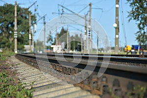 Close-up of railroad tracks with sleepers in the city during the day