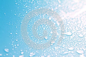 Close up rain water drops on blue sponge surface as abstract background