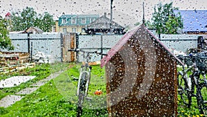Close up of raindrop window. View of the yard on a rainy day, Russia.