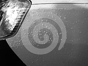 CLOSE-UP OF RAINDROPS ON CAR BODY