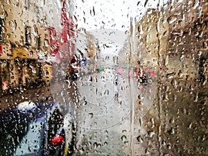 Close up of raindrops on wet glass window of a tram