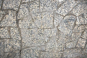 Decorative facing or sidewalk surface, made as asymmetric mosaic of gray granit pieces of different shapes.