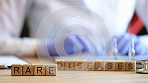 Rare disease words collected with wooden cubes photo