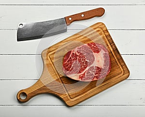Close up raw beef ribeye steak on cutting board