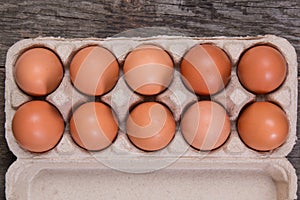 Raw chicken eggs in a paper box