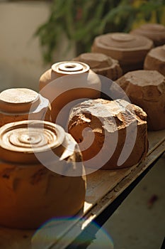 Close-up raw clay pottery chawan tea bowls drying in the sun