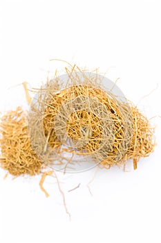 Close up of raw dried vetiver grass or khus isolated on white.