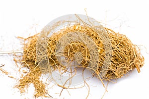 Close up of raw dried vetiver grass or khus isolated on white.