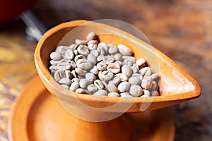 close up raw green coffee bean in pottery cup