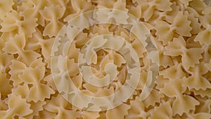 Close up of raw Italian farfalle pasta, rotating