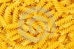 Close-up of raw pasta, texture or background Fusilli. Raw and Dry Macaroni. Italian Culture