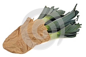 Raw leeks in a paper bag on a white background photo