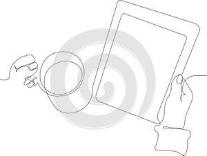 close up of reading e-book with cup of hot drink