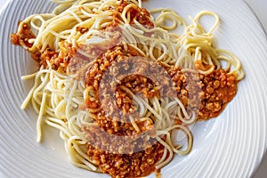 Close up spaghetti with sauce on white plate