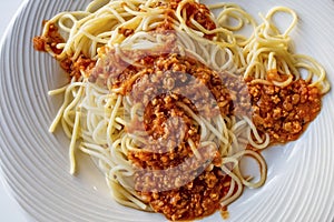 Close up spaghetti with sauce on white plate