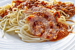 Close up spaghetti with sauce on white plate