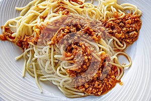 Close up spaghetti with sauce on white plate