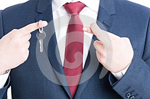 Close-up of real estate agent showing keying and fingers crossed