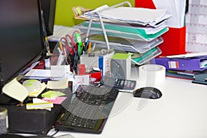 Close-up of real life messy desk in office photo