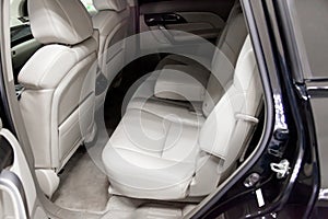 Close-up on the rear car seat with gray leather trim and seat belt in the interior after detailing