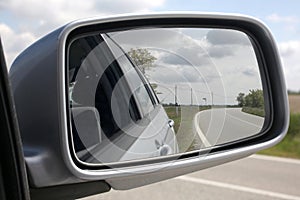 Close up on a rear external car rear mirror with clipping path