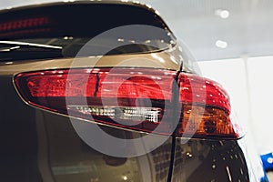 Close up of rear lights detail of modern luxury car with projector lens for low and high beam. Front view of sport