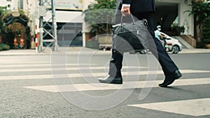 Close up rear view of a hurry aucasian middle aged business man in leather shoes and suit on the way to the office