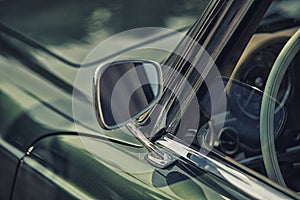 Close up on Rear view mirror on greenv intage car. photo