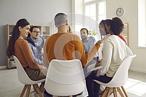 Close up rear view on people group sitting in circle discussion at modern office