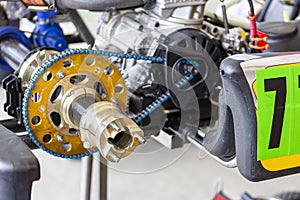 Close up rear wheel hubs with spindle of sport go kart  mini racing car during check and maintenance at service station