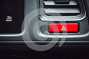 Close up of rectangle shape red color car emergency button on the dashboard in luxury car