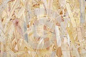 Close up of a recycled compressed light brown wood chippings board textured background. Abstract texture background
