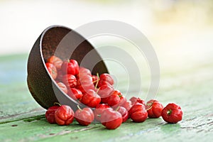 Red Acerola Cherry in wooden bowl photo