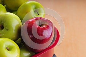 Close-up of a red apple amidst green ones