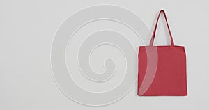 Close up of red bag on white background, copy space, slow motion