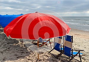 Close up of red beach umbrella and ocean scene.