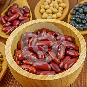 Close up red beans in beige wooden cup