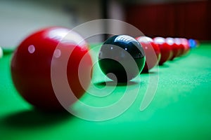 Close up of red and black balls on Snooker table