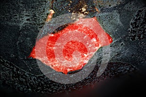 Close-up of a red and black Pottery Glacing