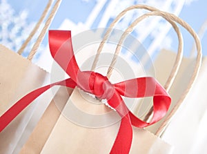 Close up of red bow tied to brown paper bag