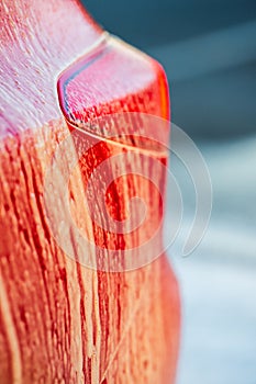 Close up of red car covered in thick soap foam..