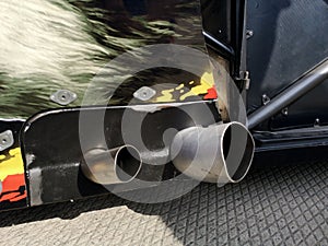 Close up of a red car dual exhaust pipe