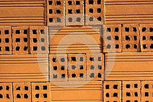 Close-up red clay bricks of rough shape